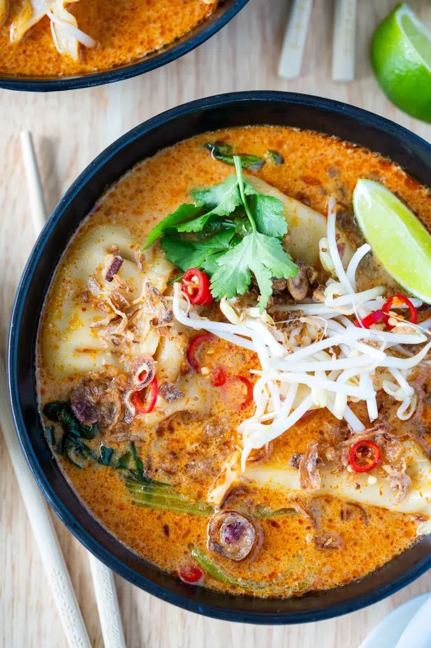 Close-up of Dumpling Laksa Soup Recipe in a black bowl