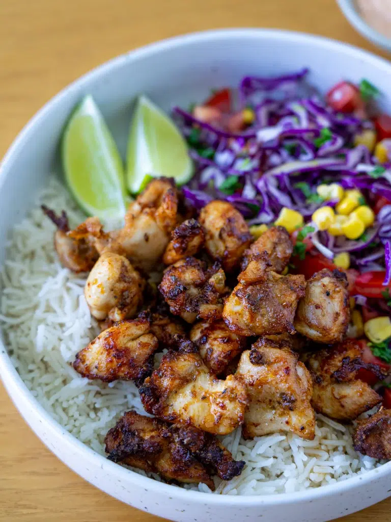 Overhead view of Peri Peri chicken and rice on a plate.